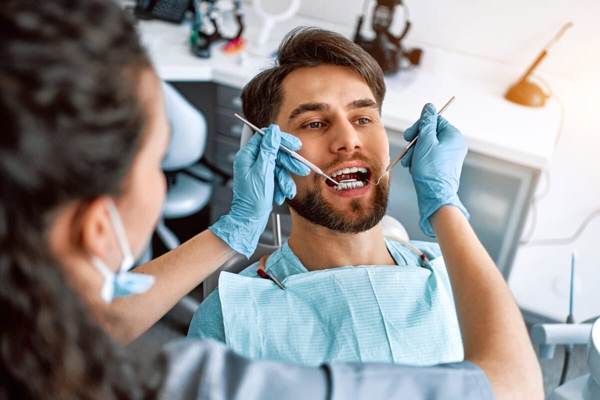 A visit to the dentist. Close-up portrait of a patient with teeth with braces.